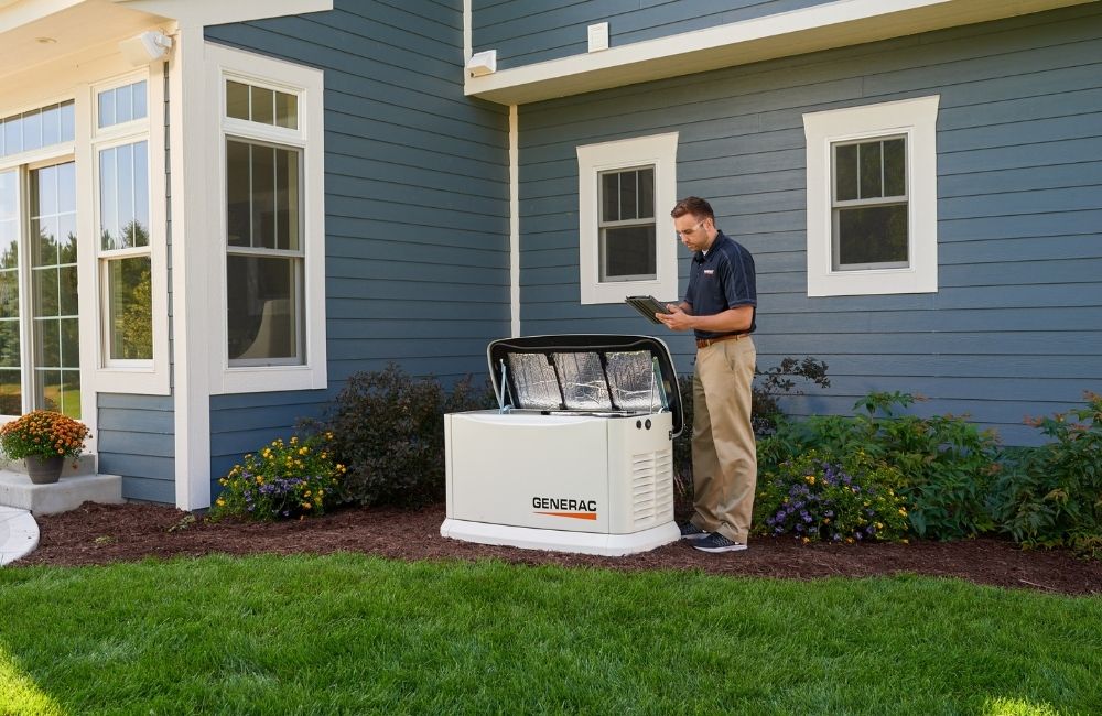 A Genstar Generator Service team member taking notes on the repairs they did for a homeowner on a Generac Generator
